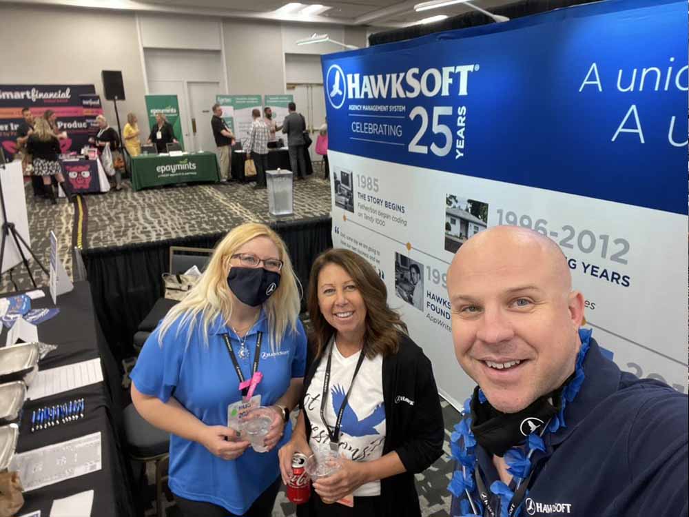 Blog - HawkSoft Employees Sarah, Dion, and Brandon Work the HawkSoft Booth in the Exhibit Hall