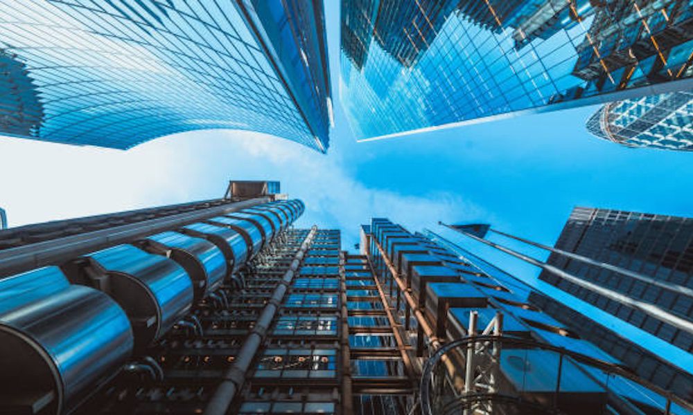 Expanding Your Role/ Risk Management as a Business Development Tool - Photo at the bottom of skyscrapers looking up at the sky